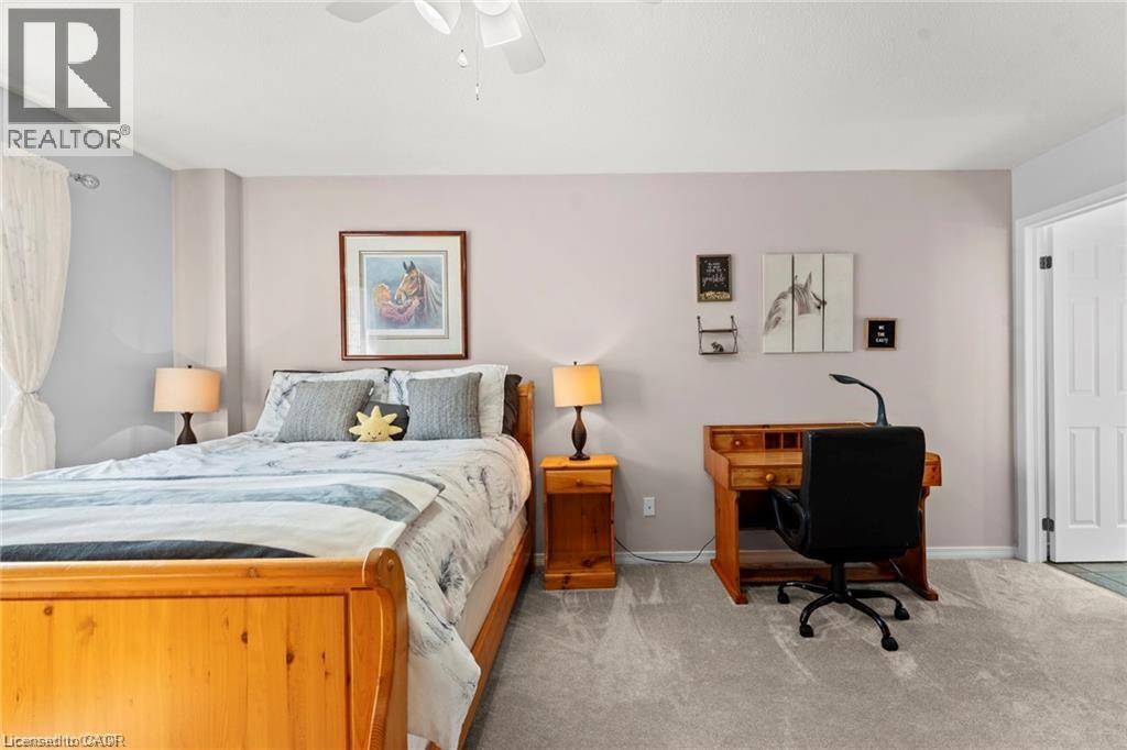 Carpeted flooring throughout, light-toned wall paint, ceiling fan, and a white interior door - 26 Shadyridge Place, Kitchener, ON