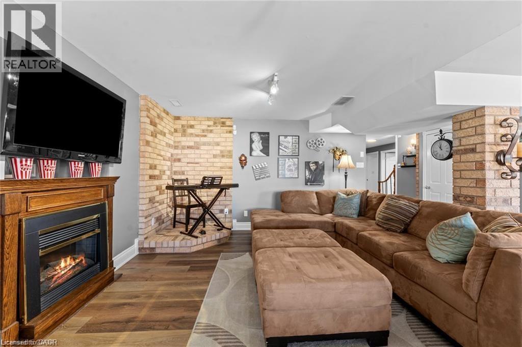 Living area featuring wood-finish flooring and light gray walls - 26 Shadyridge Place, Kitchener, ON