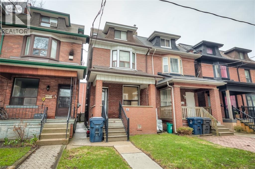Brick exterior featuring a gabled dormer and bay window - 41 Springhurst Avenue, Toronto, ON