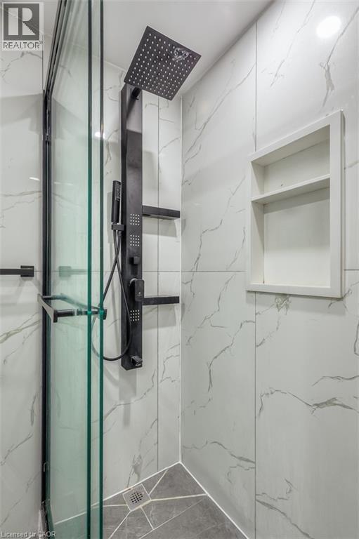 Shower enclosure featuring a matte black rain shower head, hand-held shower, and body jets - 41 Springhurst Avenue, Toronto, ON