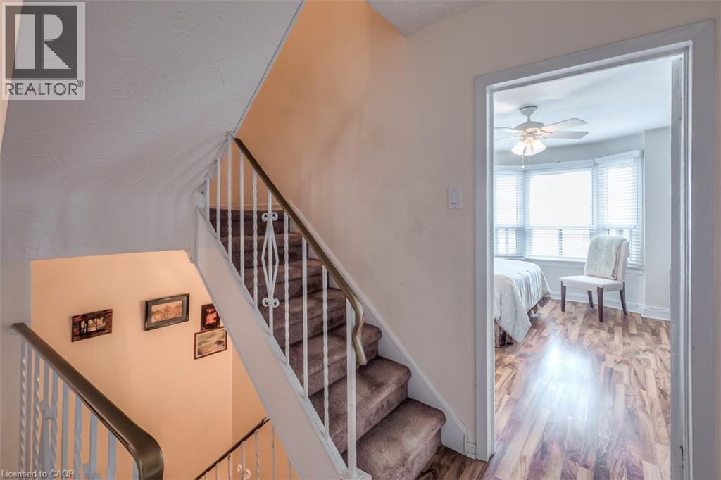 Carpeted staircase with white wrought iron railing - 41 Springhurst Avenue, Toronto, ON