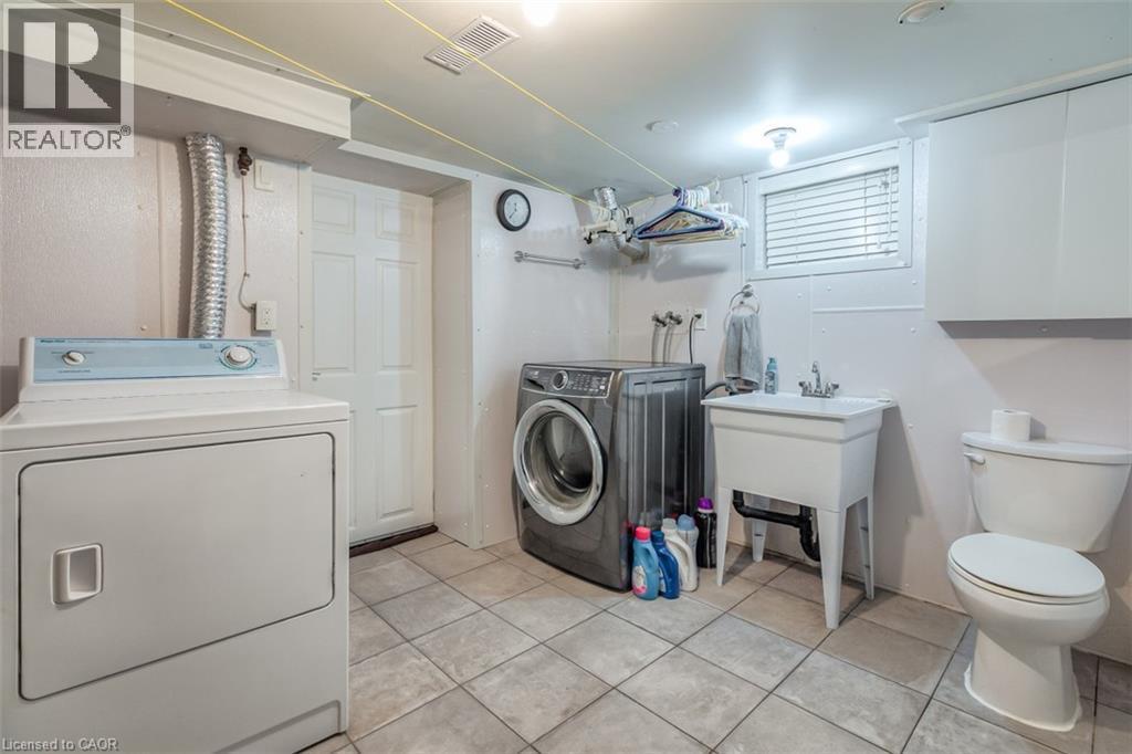 Dedicated laundry area featuring tile flooring - 41 Springhurst Avenue, Toronto, ON