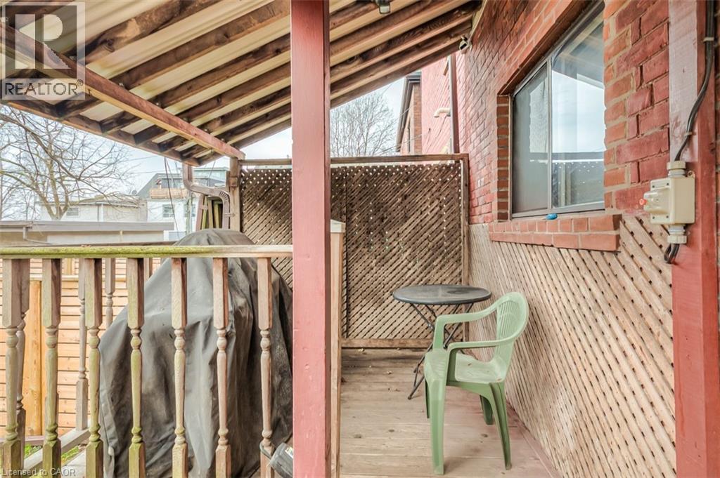 Covered outdoor deck area featuring a wood railing and lattice privacy screens - 41 Springhurst Avenue, Toronto, ON