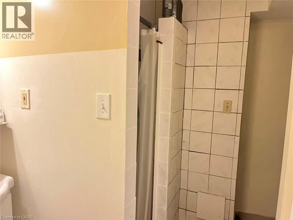 Tiled shower enclosure with white ceramic tile - 110 Peppler Street, Waterloo, ON