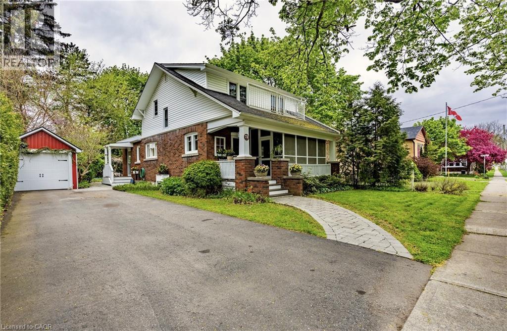 1 1/2 wide paved driveway, detached single car garage, side covered porch and interlocking brick walkway to the front door and covered screened porch. - 72 Crescent Boulevard, Simcoe, ON - Outdoor With Facade
