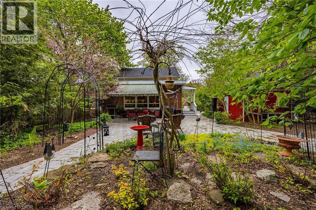 Back of the house from the thoughtfully landscaped backyard - 72 Crescent Boulevard, Simcoe, ON - Outdoor With Deck Patio Veranda
