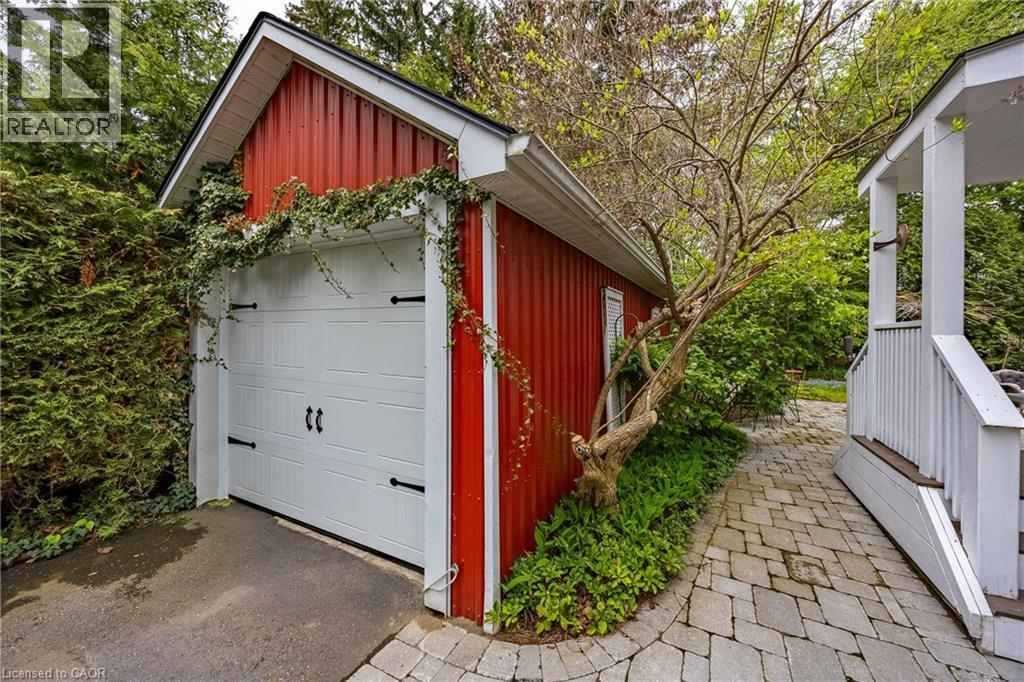 Single car detached garage and updated covered side-door porch wiith composite deck and steps - 72 Crescent Boulevard, Simcoe, ON - Outdoor With Exterior
