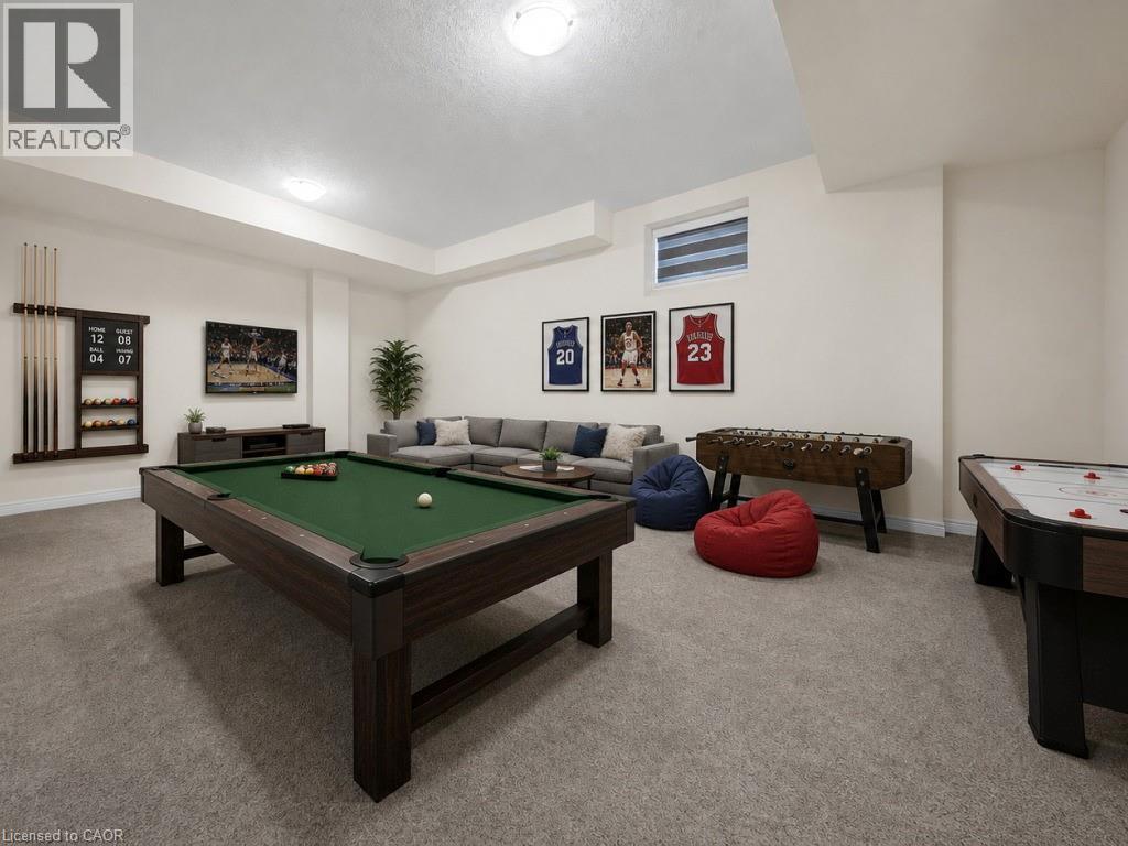 Spacious recreation room featuring neutral carpeting, recessed lighting, and a window with horizontal blinds - 76 Grassbourne Avenue, Kitchener, ON