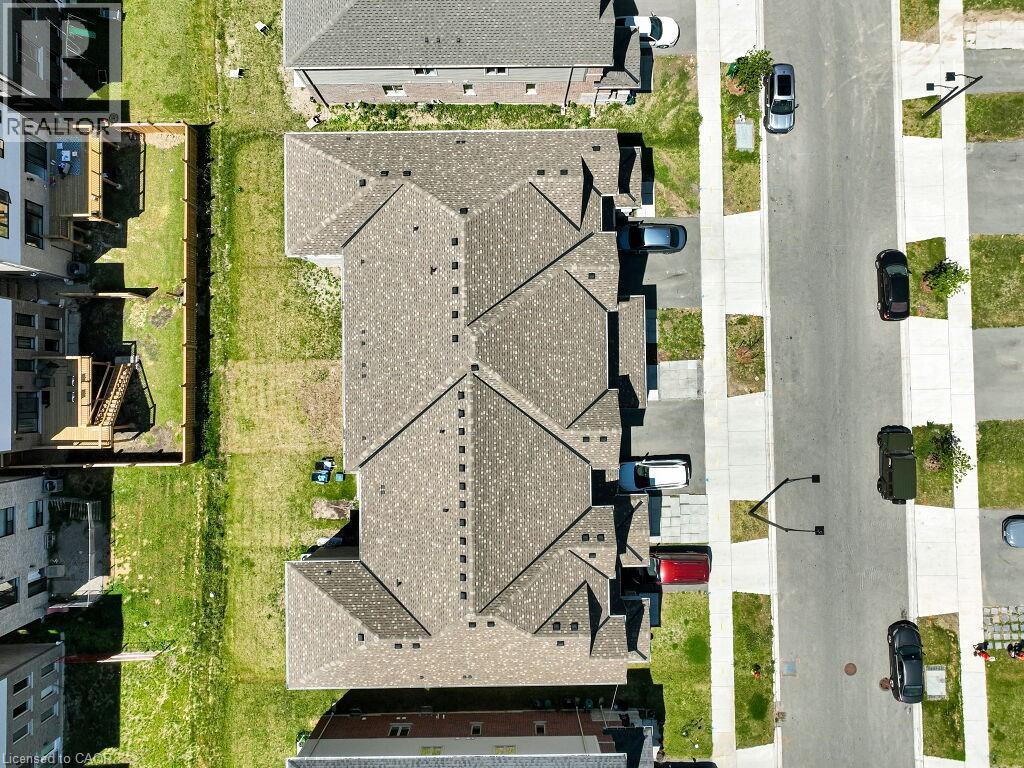 New construction residential row with asphalt shingle roofing - 76 Grassbourne Avenue, Kitchener, ON