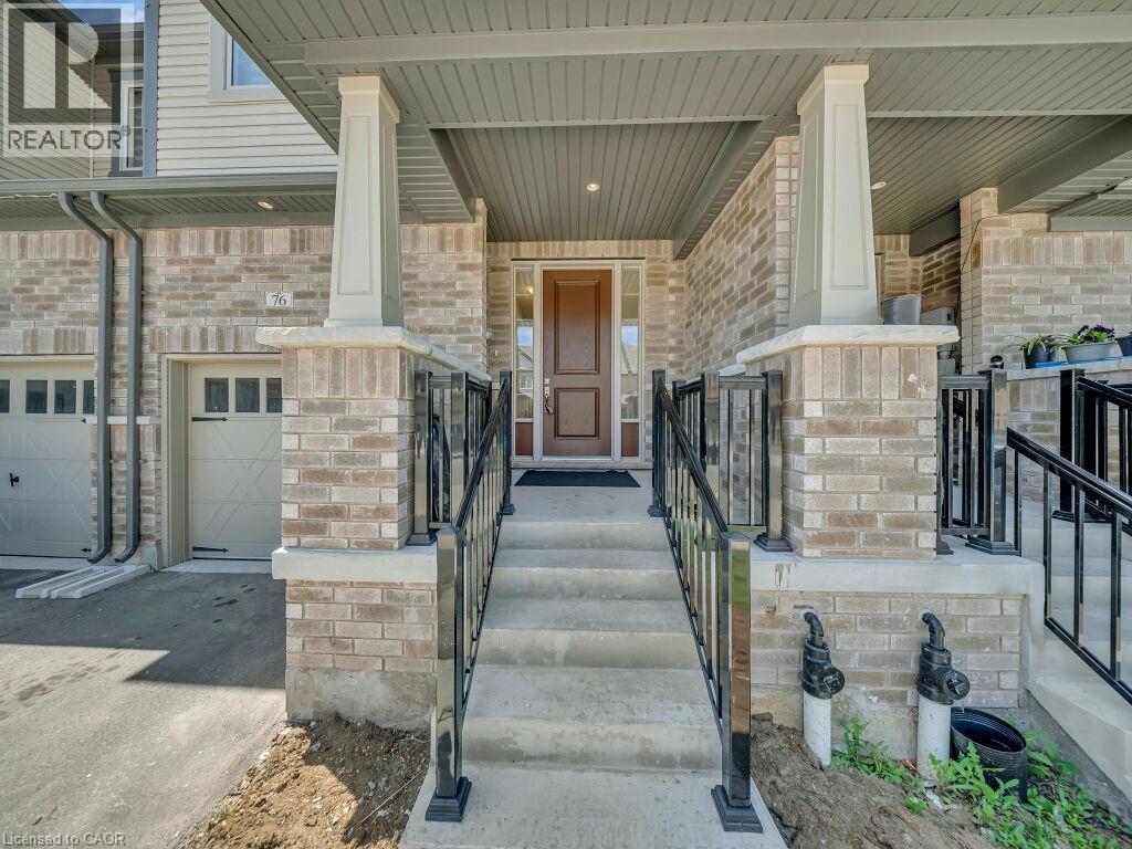 Inviting front porch featuring a brown wood-panel front door, light-colored brick exterior, concrete steps with black metal railings, and a single-car garage with a panel-style door - 76 Grassbourne Avenue, Kitchener, ON