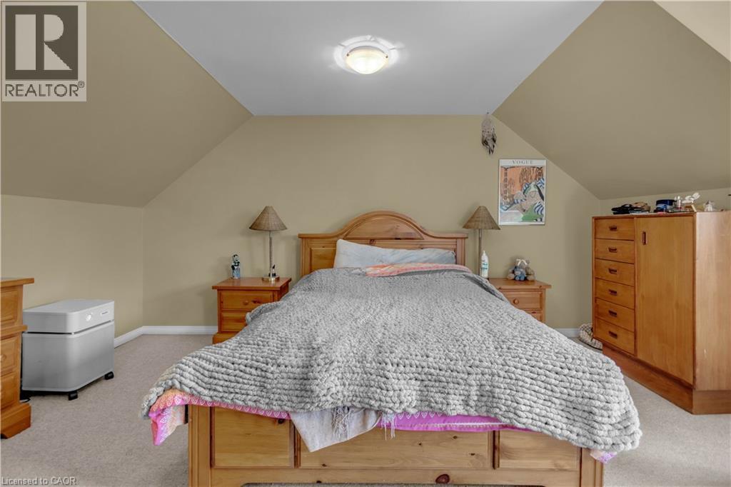 Carpeted room featuring sloped ceilings, recessed lighting, and neutral wall paint - 30 Sunset Avenue, Hamilton, ON