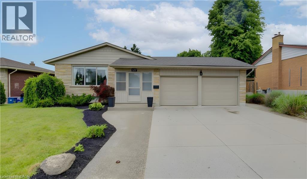 Front exterior with stone facade and horizontal siding - 127 Strathcona Crescent, Kitchener, ON