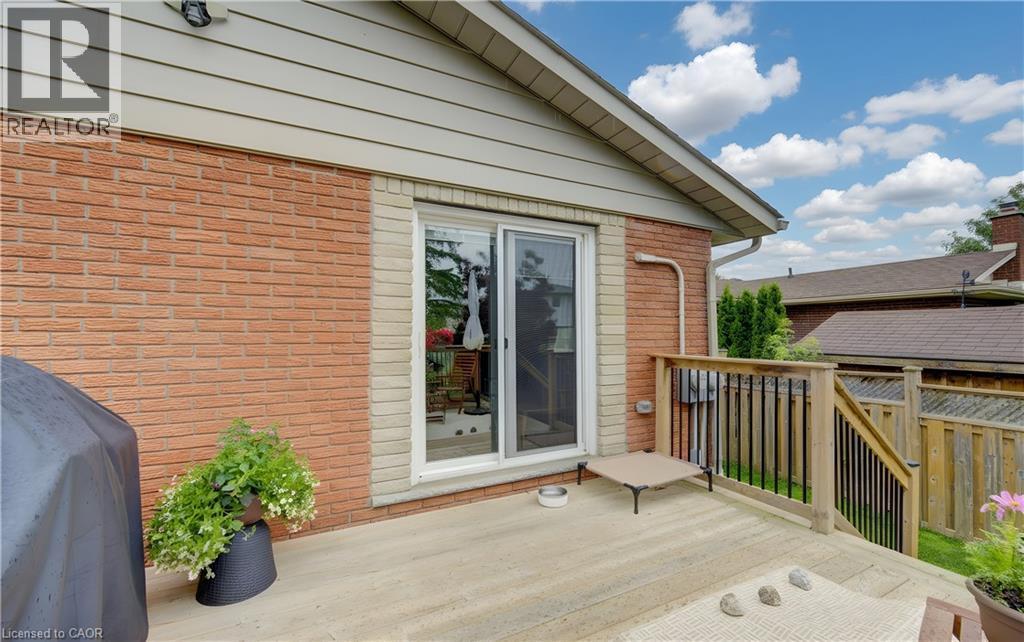 Expansive outdoor deck featuring wood flooring and a perimeter railing - 127 Strathcona Crescent, Kitchener, ON