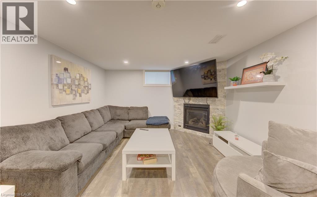 Finished living space featuring wood-finish flooring and recessed lighting - 127 Strathcona Crescent, Kitchener, ON