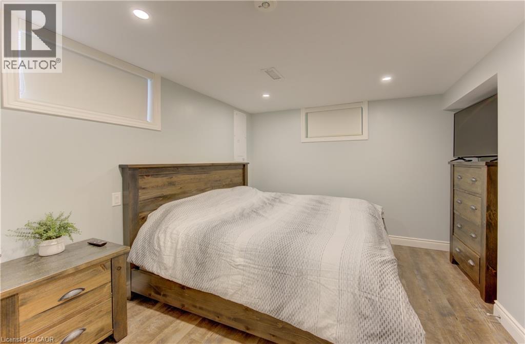 Wood-finish flooring with light-colored walls and white trim - 127 Strathcona Crescent, Kitchener, ON