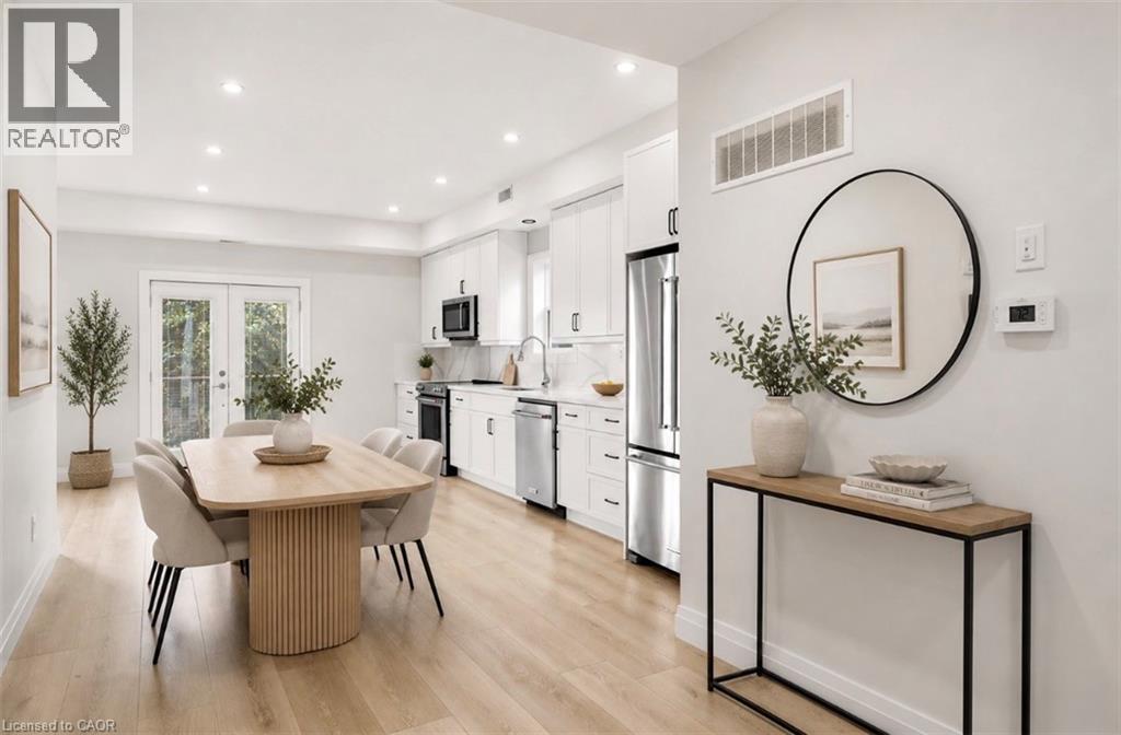Open-concept living space featuring wood-finish flooring and recessed lighting - 129 St George Street, Kitchener, ON