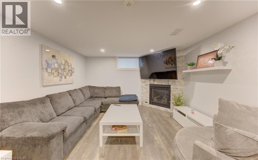 Finished living space featuring wood-finish flooring and recessed lighting - 127 Strathcona Crescent, Kitchener, ON