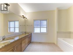 Spacious ensuite with dual vanities, granite counters, soaker tub and shower -