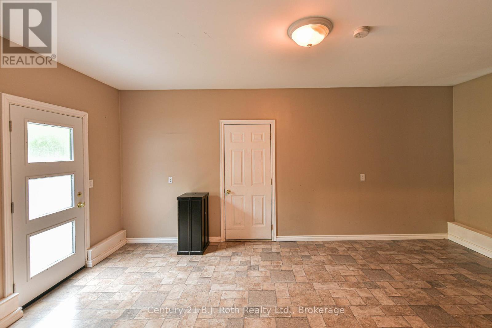 Family room leads to garage - 7463 Davy Drive, Ramara, ON