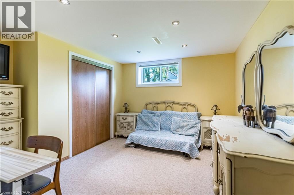 Carpeted interior space featuring a double-door closet with wood-finish panels, recessed ceiling lighting, and a single window - 1293 Daimler Road, Mississauga, ON - Indoor Photo Showing Bedroom