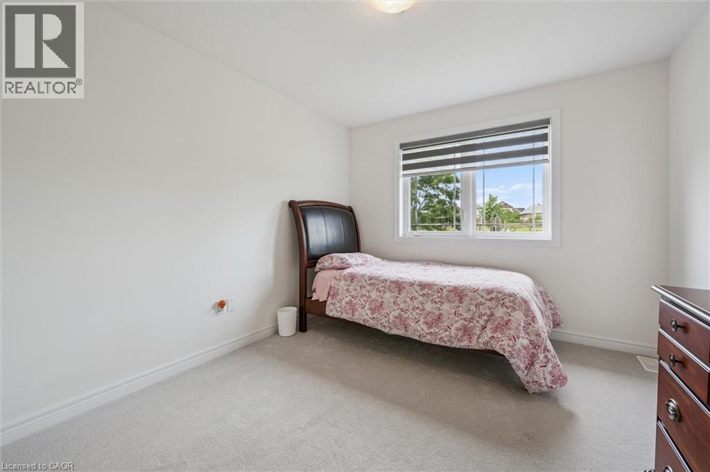 Bright room featuring light-toned carpeting and a window with horizontal blinds - 153 Rivertrail Avenue, Kitchener, ON - Indoor Photo Showing Bedroom