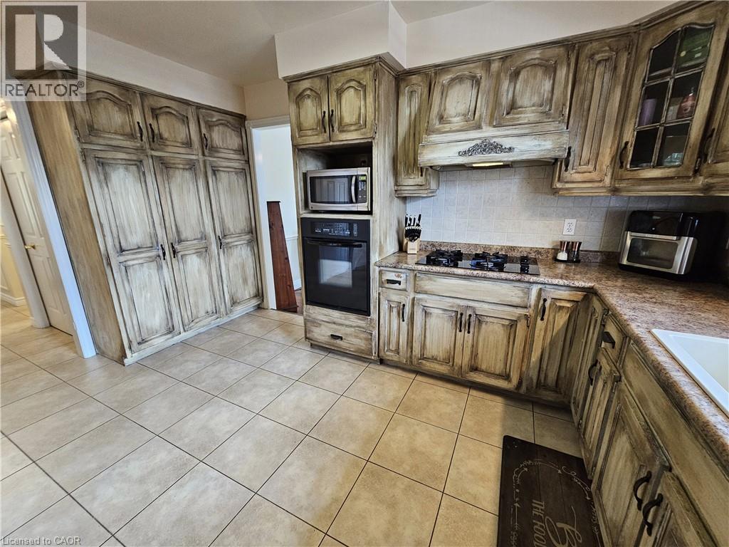 Kitchen with ample storage, integrated wall oven and a gas cooktop - 120 Lynndale Road, Simcoe, ON