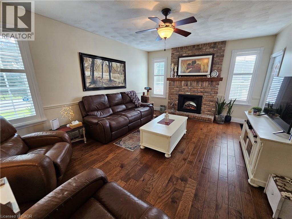 Family room features engineered hardwood, fireplace and walkout to deck - 120 Lynndale Road, Simcoe, ON
