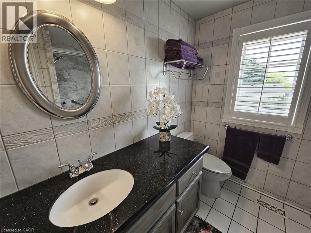 Bathroom vanity with granite countertop, undermount sink and chrome faucet - 120 Lynndale Road, Simcoe, ON