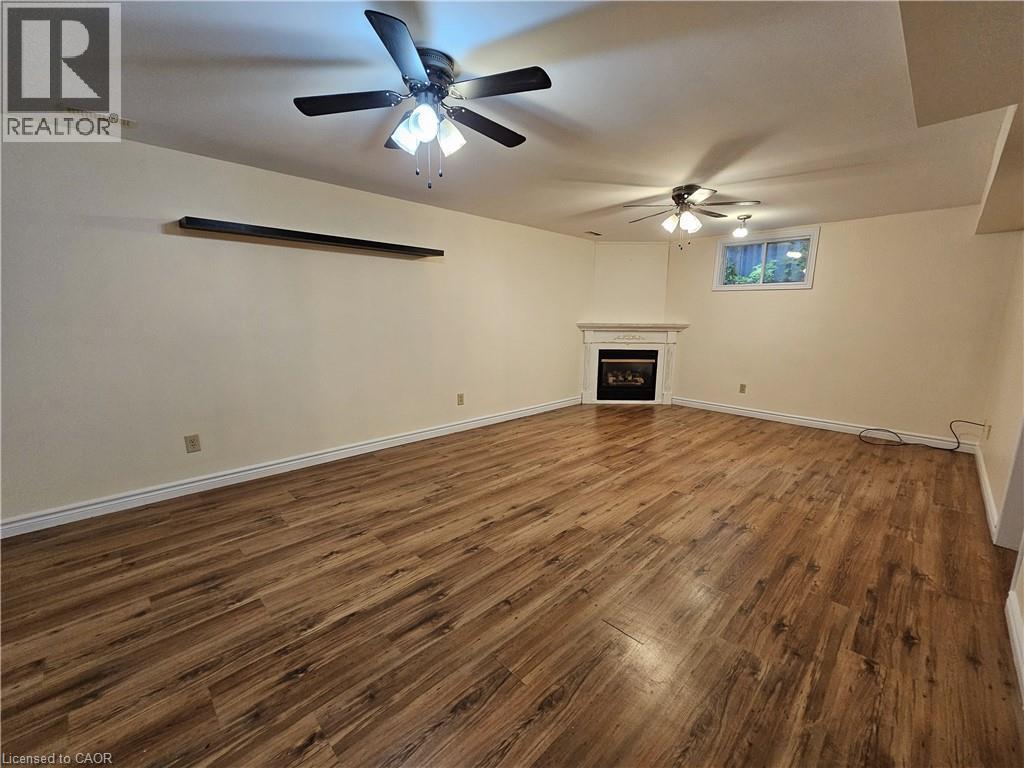Family Room in basement with gas fireplace - 120 Lynndale Road, Simcoe, ON