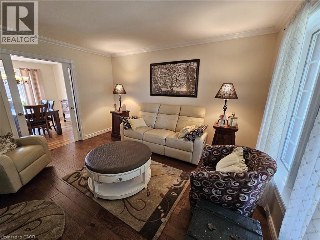 Living room featuring engineered hardwood flooring and crown molding - 120 Lynndale Road, Simcoe, ON