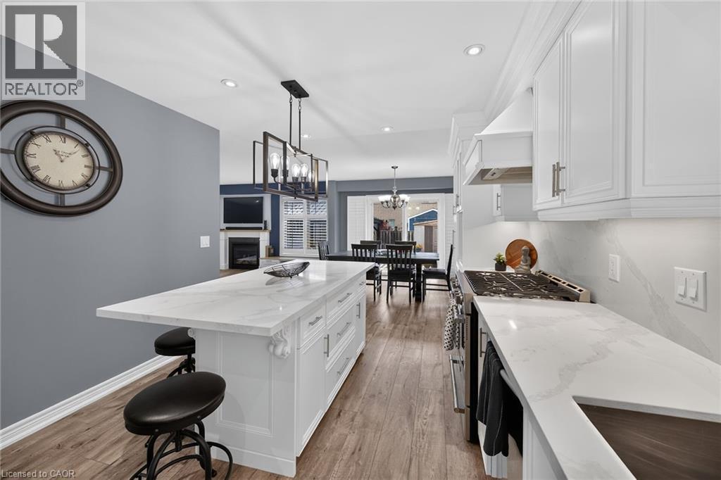 Spacious room featuring rich wood-finish flooring, light gray walls, and white trim - 43 Wilbur Drive, Binbrook, ON