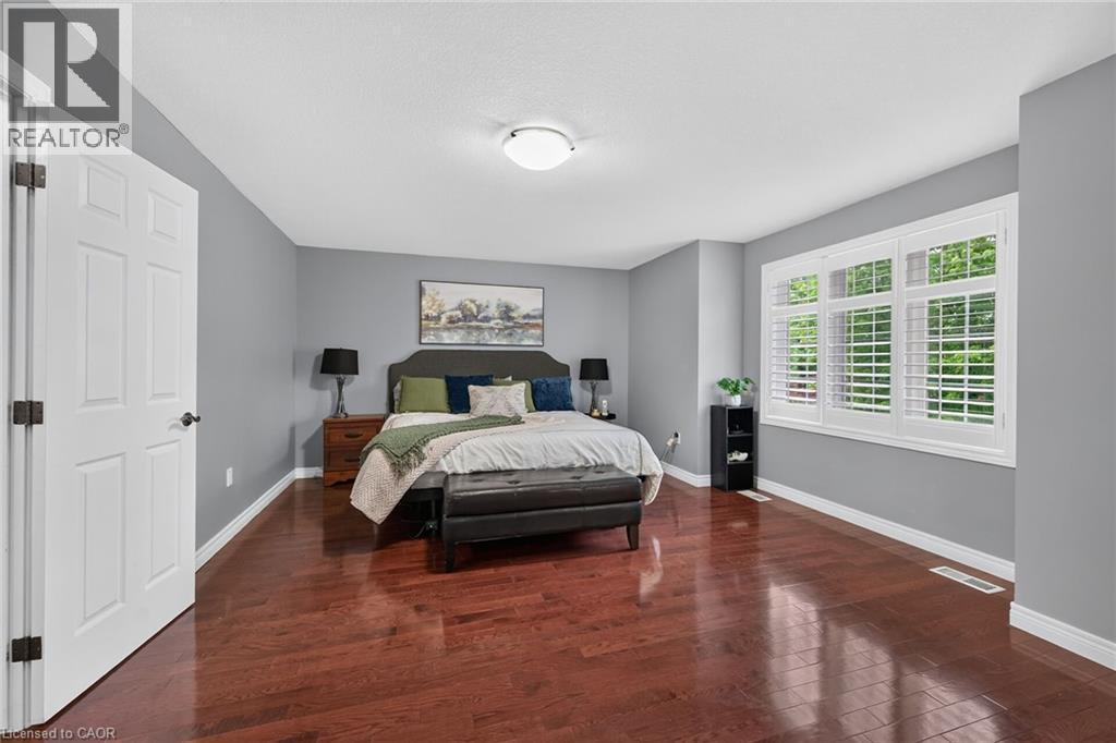 Rich wood-finish flooring with a deep cherry tone - 43 Wilbur Drive, Binbrook, ON