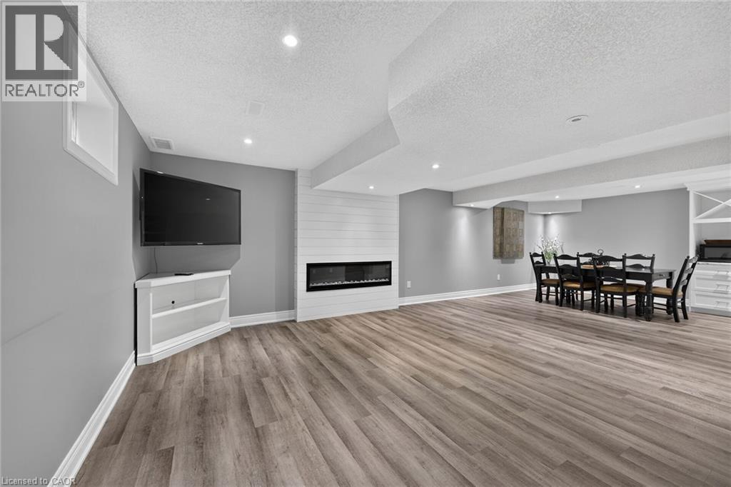 Spacious family room with electric fireplace for those cool nights. - 43 Wilbur Drive, Binbrook, ON