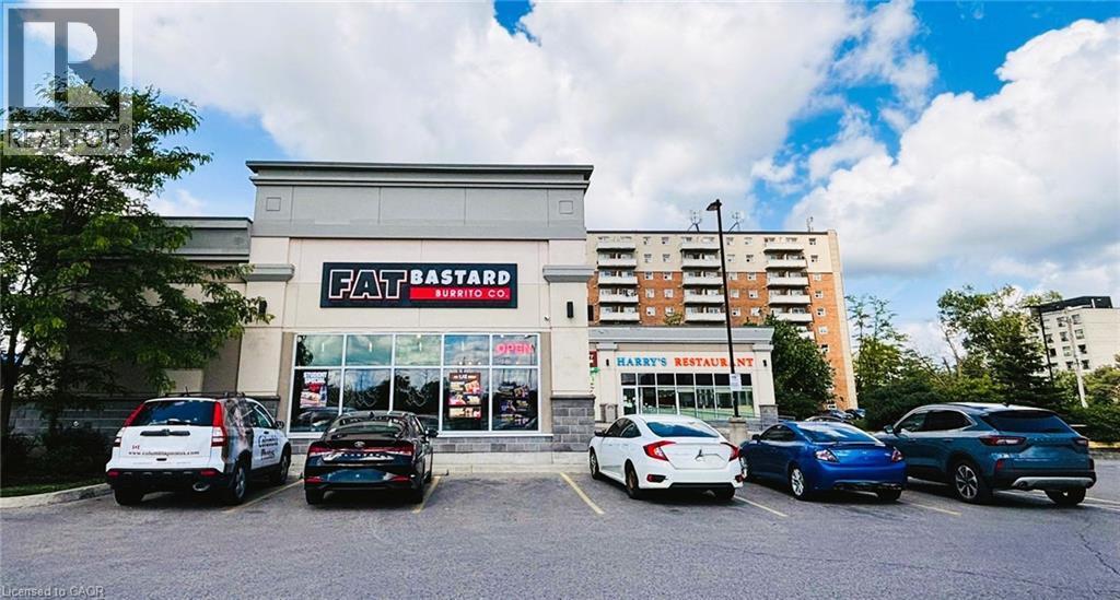 Retail storefront with prominent signage and large display windows - 457 Wharncliffe Road S, London, ON