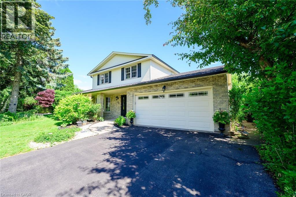 Two-story residence featuring light-colored siding and stone veneer accents - 15 Cheval Drive, Grimsby, ON - Outdoor