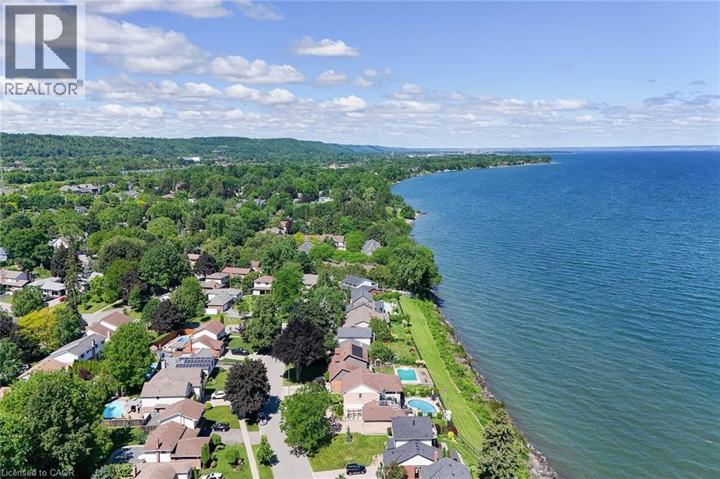 Expansive waterfront property featuring a substantial body of water, lush green shoreline, and mature trees - 15 Cheval Drive, Grimsby, ON - Outdoor With Body Of Water With View