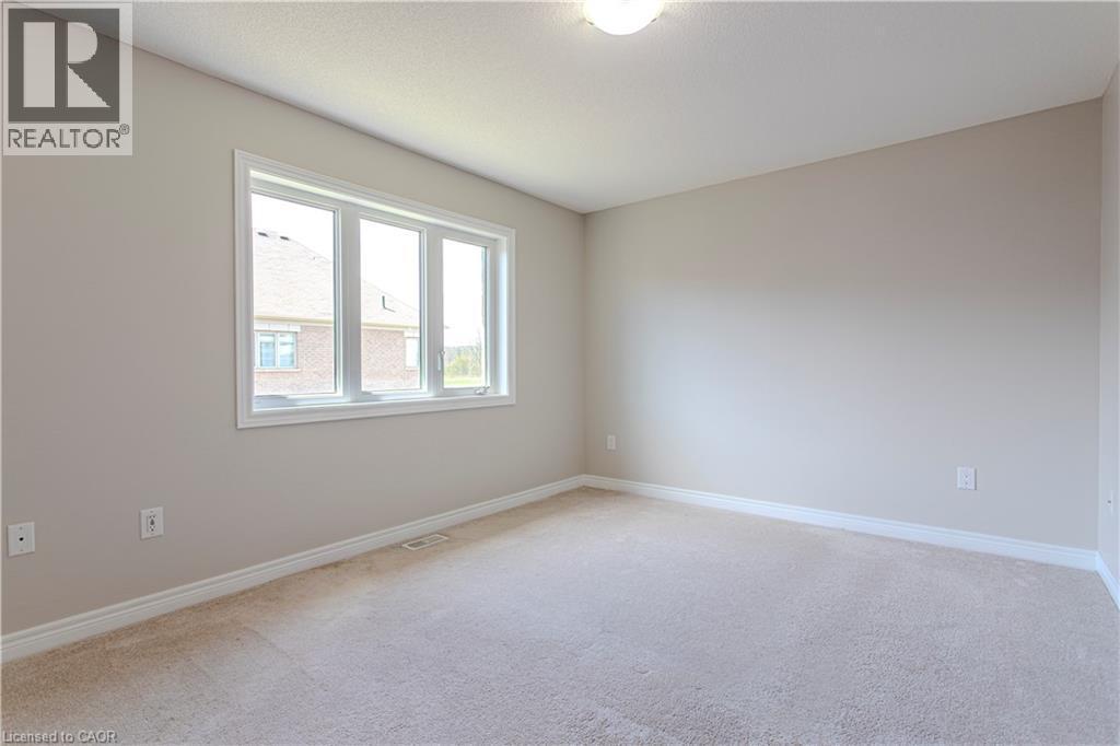 Neutral-toned room with plush carpet flooring, white baseboards, and a three-pane window - 3896 Tufgar Crescent, Burlington, ON