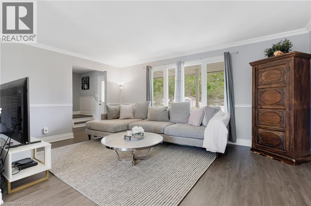 Living area featuring , light gray walls with wainscoting, white crown molding, and large windows - 139 Dorset Road, Cambridge, ON