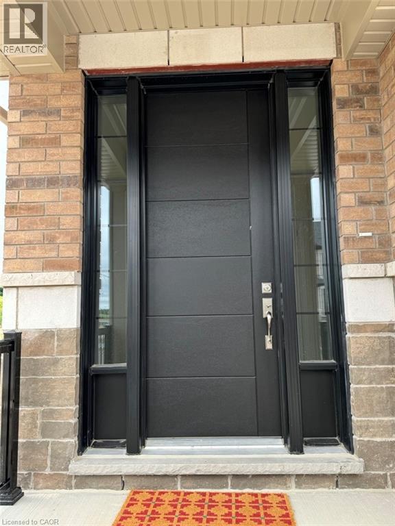 Modern black entry door with horizontal panel detailing, flanked by full-length sidelight windows - 10 Guernsey Drive Unit# Upper, Kitchener, ON