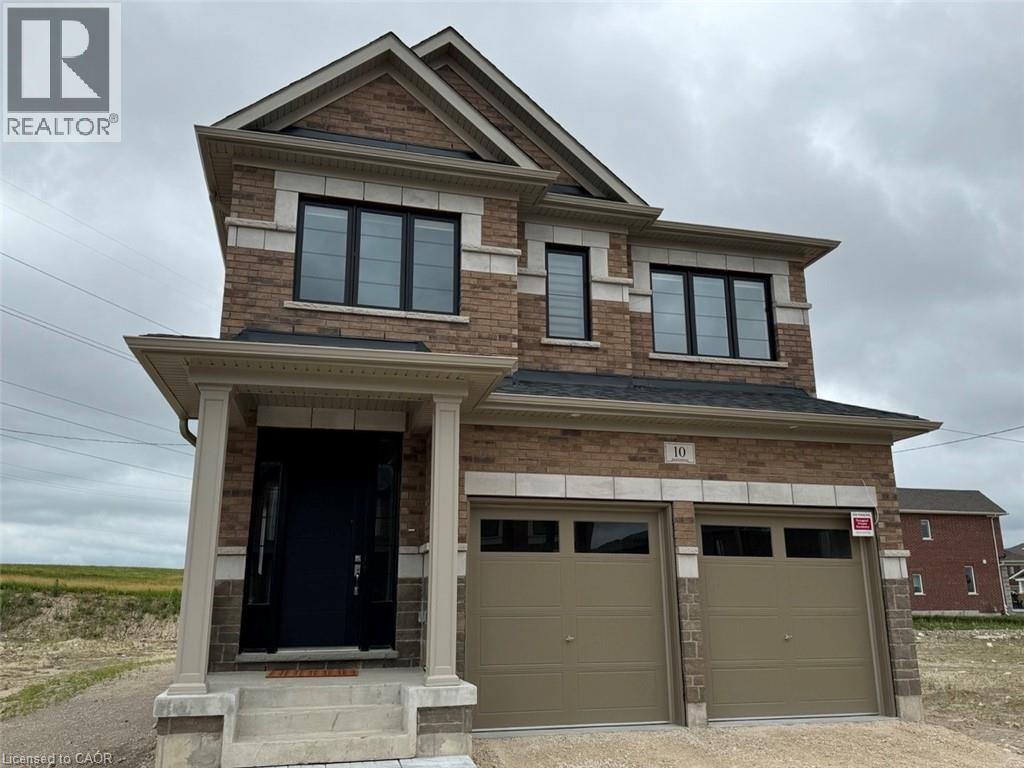 Two-story brick facade residence with stone accents and a covered front porch featuring columns - 10 Guernsey Drive Unit# Upper, Kitchener, ON