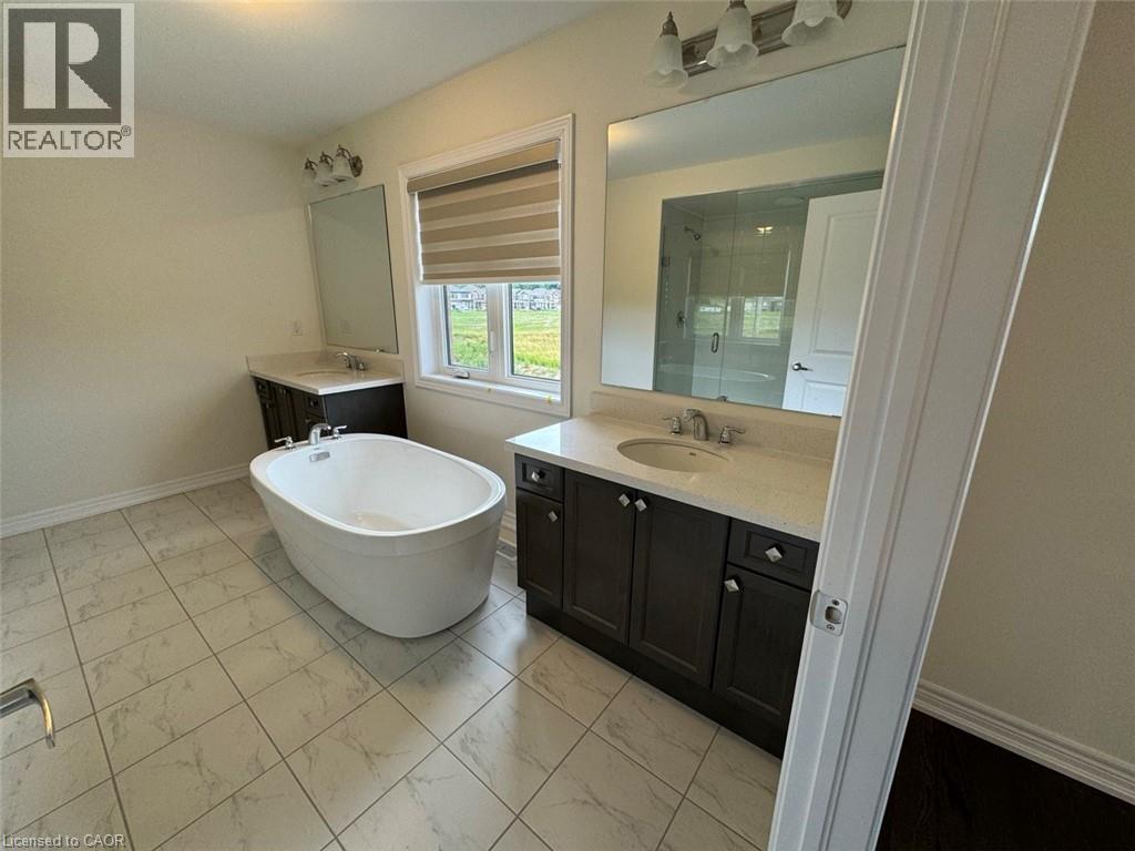 Two-story brick exterior featuring stone accents and a two-car garage - 10 Guernsey Drive Unit# Upper, Kitchener, ON