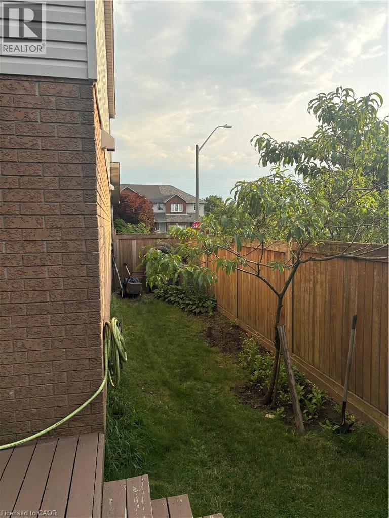 Brick and siding exterior with a wood-finish deck and stairs - 125 Terni Boulevard, Hamilton, ON - Outdoor