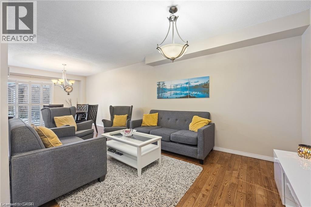 Recessed ceiling, wood-finish flooring, and a chandelier lighting fixture - 125 Terni Boulevard, Hamilton, ON - Indoor Photo Showing Living Room