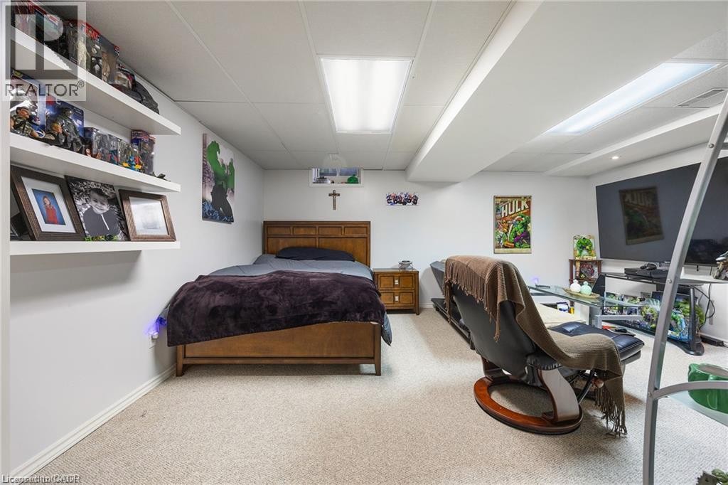 Wall-mounted shelving, built-in ceiling lighting, and light-toned carpeting - 125 Terni Boulevard, Hamilton, ON - Indoor Photo Showing Bedroom