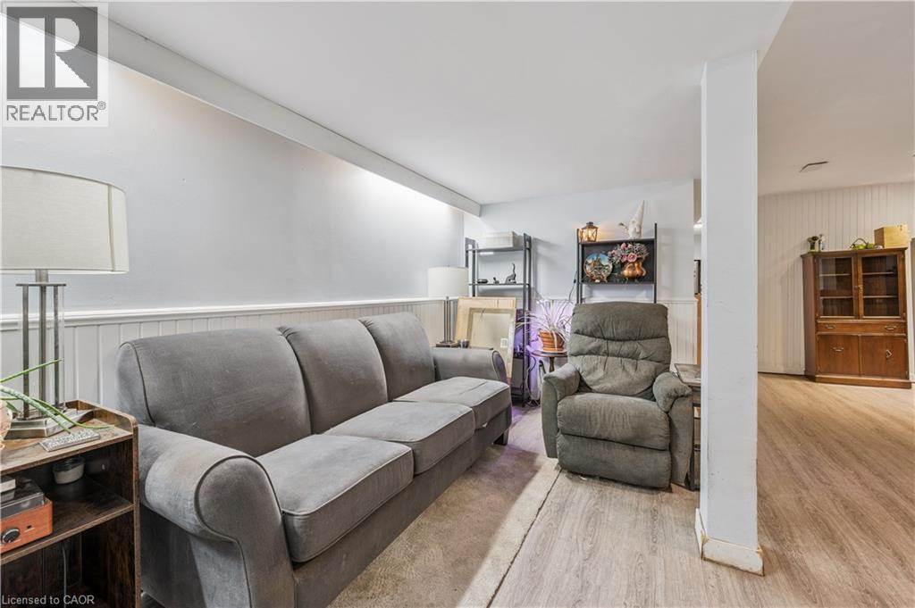 Versatile bonus room featuring wood-finish flooring, wainscoting, and recessed lighting - 35 Vicmount Drive, Kitchener, ON
