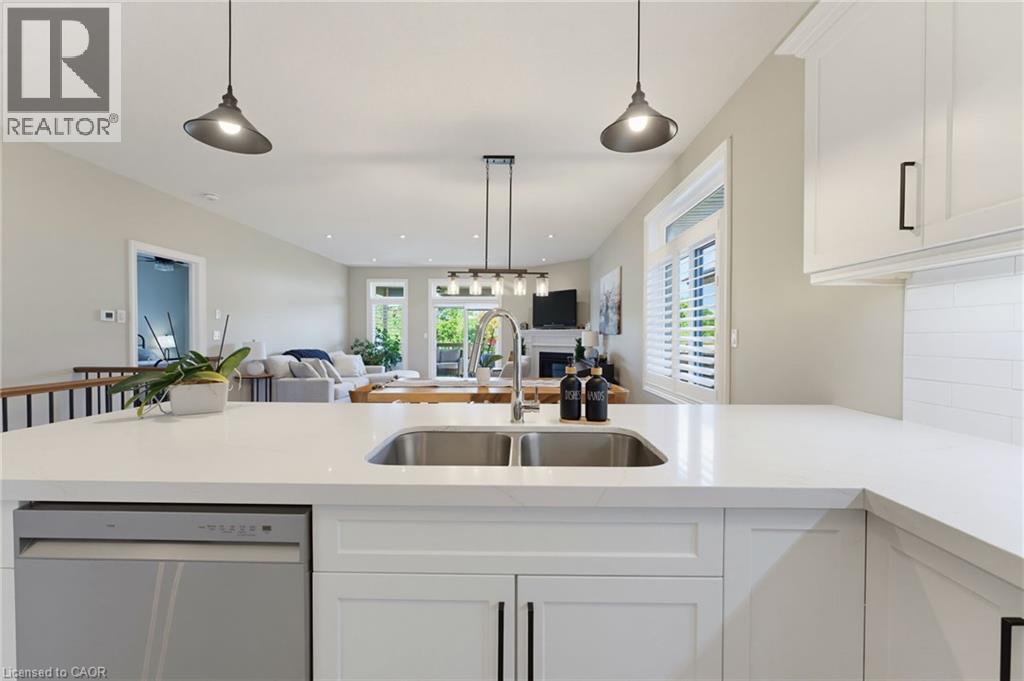 The heart of the home features a beautiful open concept kitchen with quartz countertops - 131 Craddock Boulevard, Haldimand, ON