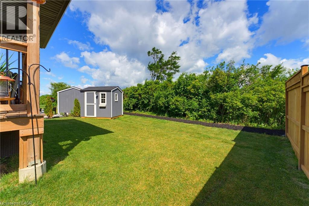 The backyard is ready for family barbecues, morning coffee and quiet evenings under the stars. - 131 Craddock Boulevard, Haldimand, ON