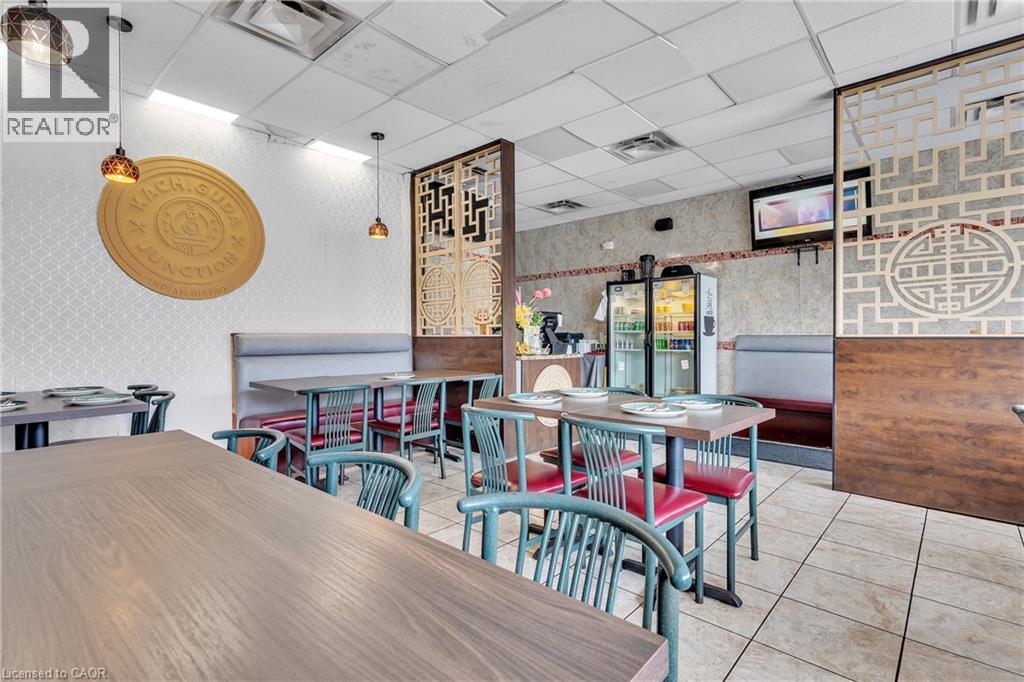 Commercial interior featuring tiled flooring and drop ceiling with recessed lighting - 155 Highland Road E, Kitchener, ON