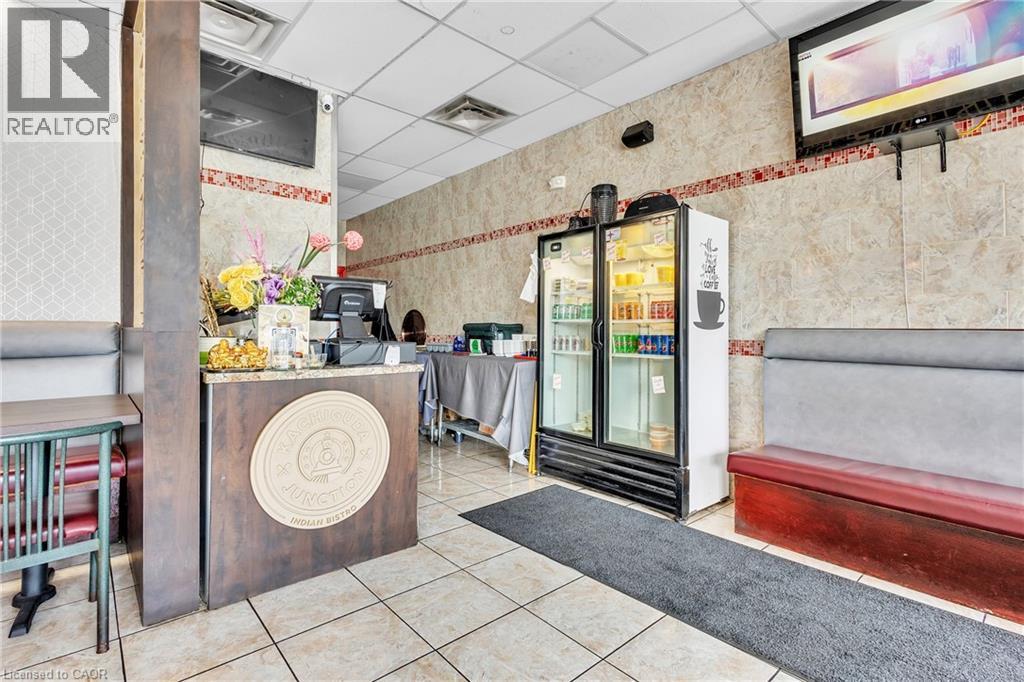 Tiled flooring and wall accents complement the functional counter space and built-in booth seating - 155 Highland Road E, Kitchener, ON