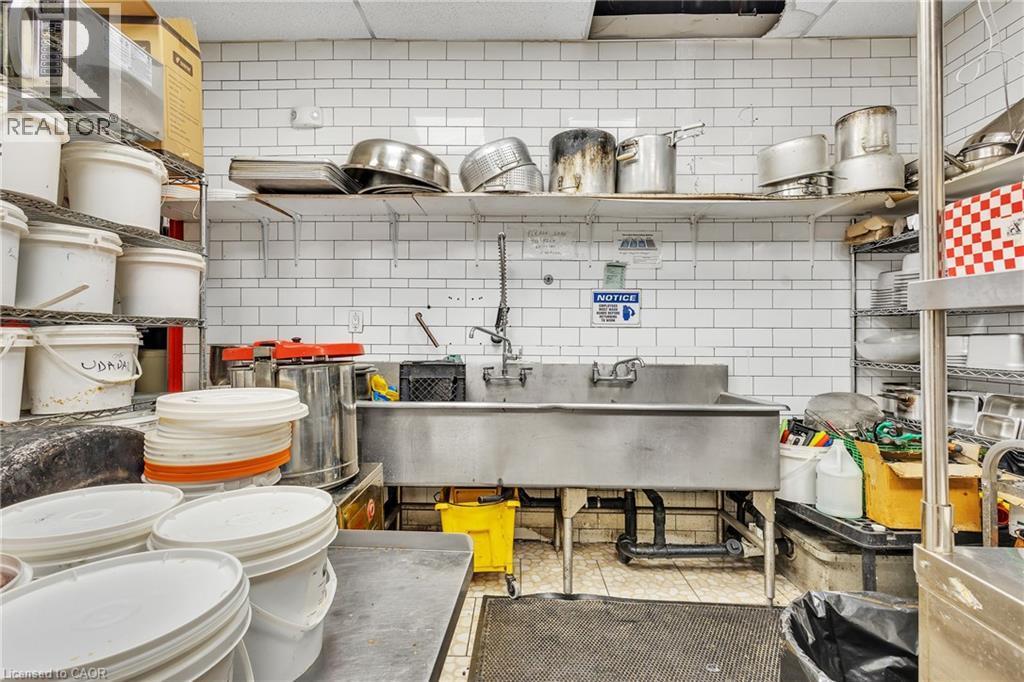Industrial stainless steel triple sink with wall-mounted faucets - 155 Highland Road E, Kitchener, ON